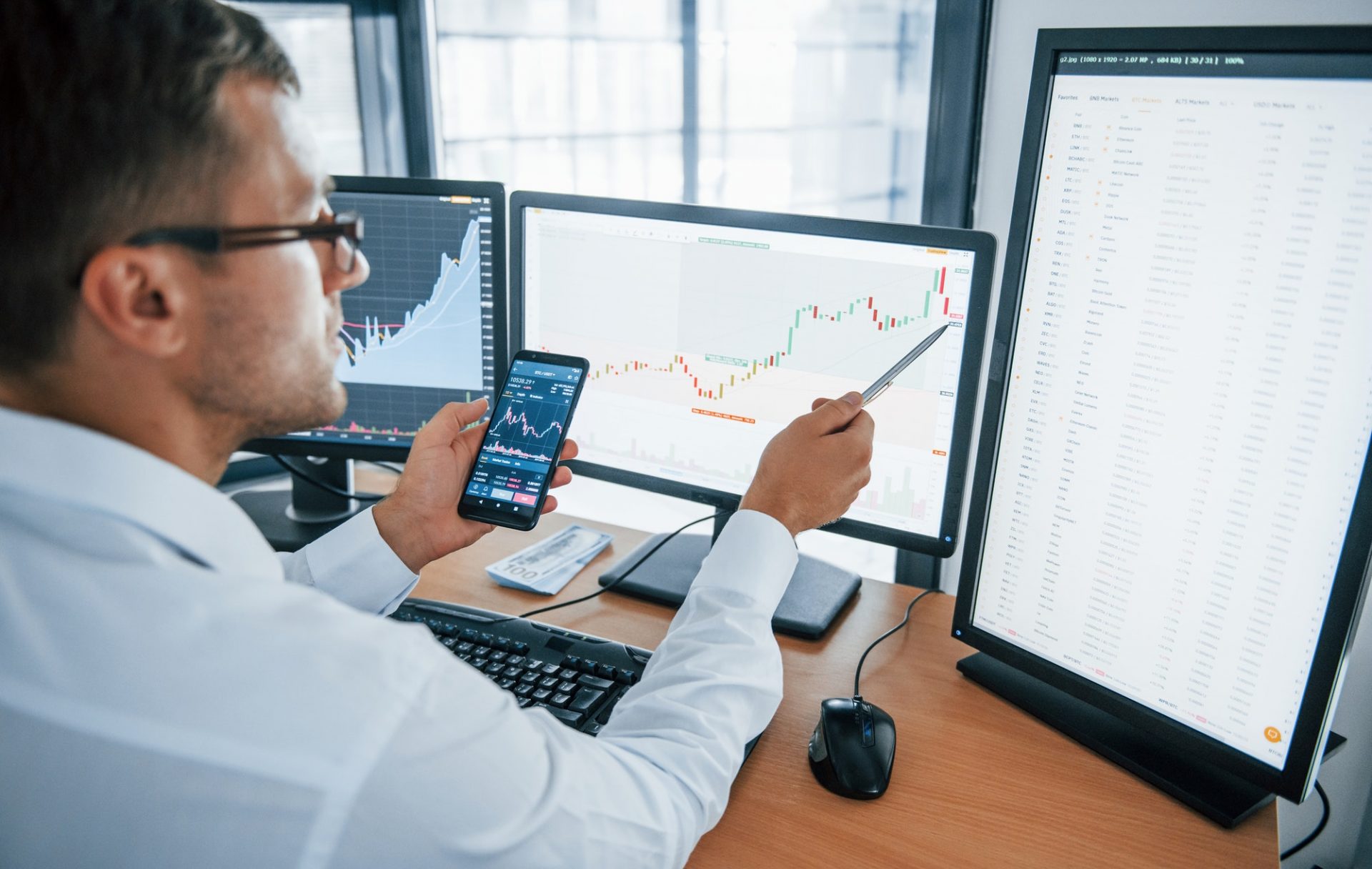 Young Businessman In Formal Clothes Is In Office With Multiple Screens E1616121983333